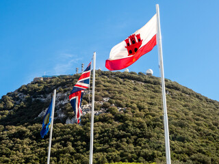 Gibraltar, UK and Commonwealth flags fly at the Rock of Gibraltar