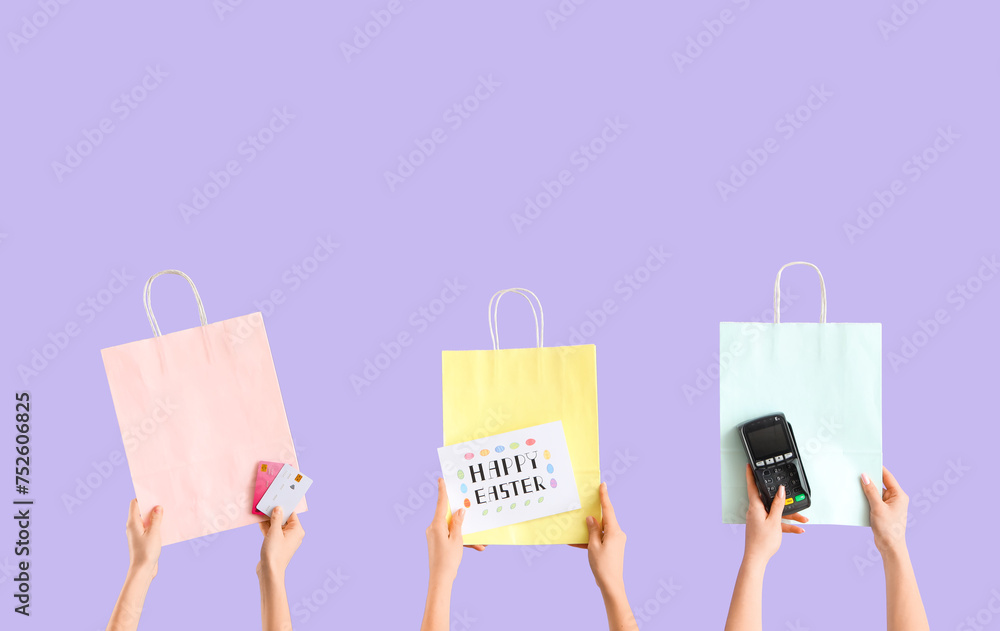 Poster Women with payment terminal, credit cards and shopping bags on lilac background. Easter Sale