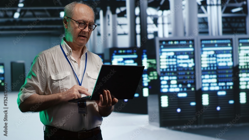 Poster skillful it professional navigating network of servers in industrial facility. developer with laptop