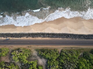 Aerial view of shoreline road and beach at Kekaha on Kauai