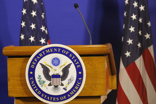 United States of America Department of State logo and flag on stage for press conference announcement - Rio de Janeiro, Brazil 02.22.2024