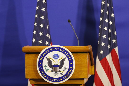United States of America Department of State logo and flag on stage for press conference announcement - Rio de Janeiro, Brazil 02.22.2024