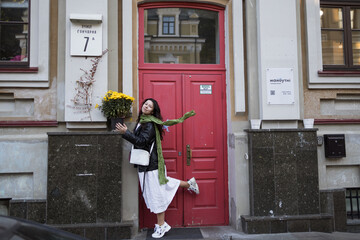 Curly-haired woman with a green scarf