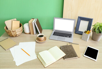 Stylish workplace with tablet, stationery and laptop in office