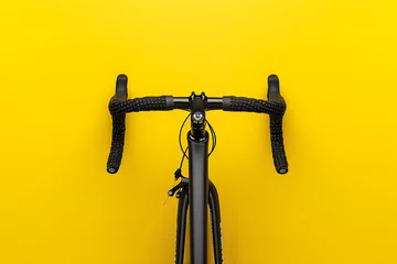  cyclist with a racing bike, top view, isolated on a speed-inspired bright yellow background, denoting motion and endurance © STUDIO COLORS