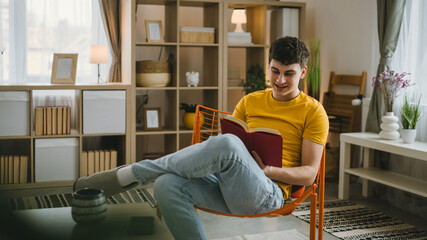 Young man caucasian teenager read book study at home education concept