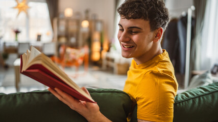Young man caucasian teenager read book study at home education concept