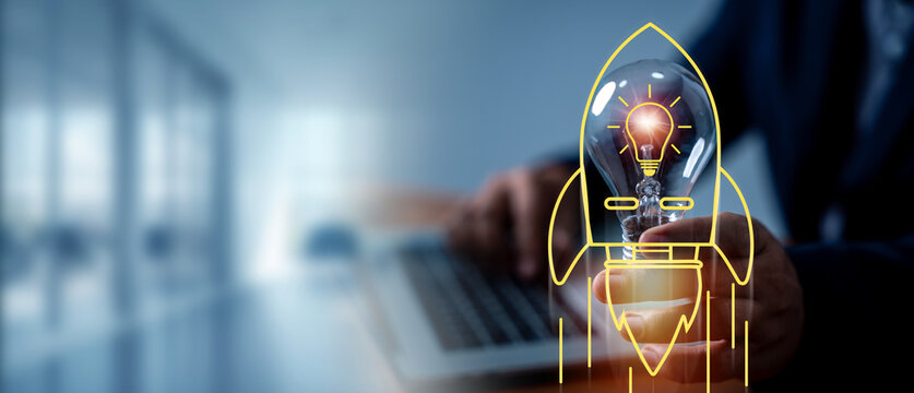 Businessman holding light bulb with rocket icon take to new idea, creative thinking idea and problem-solving solution concept. Inspiration and innovation concept, leadership, success