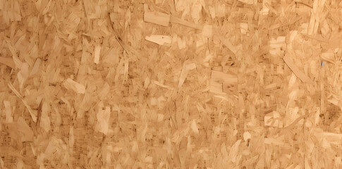 Tileable 3D rendering of a light brown background texture made from compressed wood particle board such as redwood pine oak fiberboard plywood or OSB Copy space image Place for adding text or d