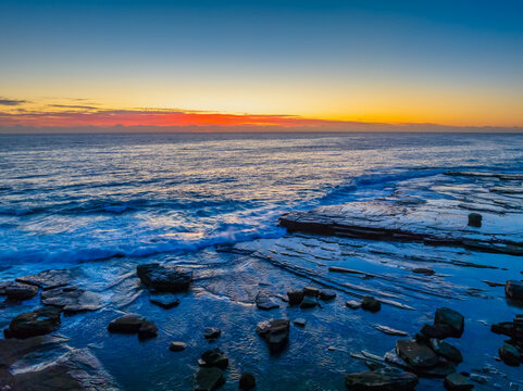 Sunrise blues over the sea and rocky Inlet