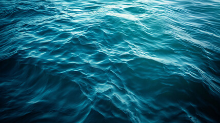 Blue green surface of the ocean in Catalina Island California with gentle ripples on the surface and light refracting.
