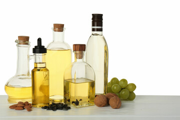 Vegetable fats. Different cooking oils and ingredients on wooden table against white background