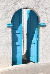 Traditional greek door set in lime-washed walls.