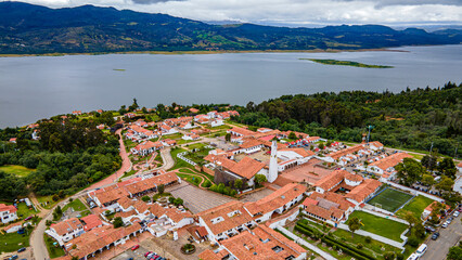 Aerial view of Guatavita, Cundinamarca showcasing the town’s architecture, lush greenery, and...