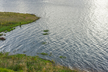 Serene view of Embalse de Tominé in Guatavita, Cundinamarca with lush greenery