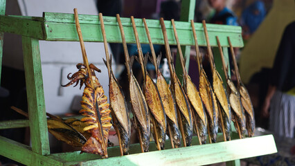 Smoked fish or fish that is preserved by smoking, smoked fish food. Smoked fish clamped with bamboo...
