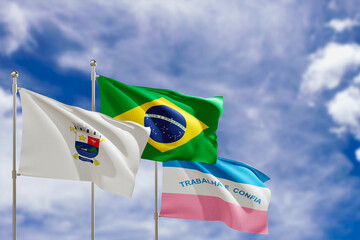 Official flags of the country Brazil, state of Espirito Santo and city of Vitoria. Swaying in the wind under the blue sky. 3d rendering