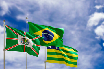 Official flags of the country Brazil, state of Goias and city of Goiania. Swaying in the wind under the blue sky. 3d rendering