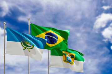Official flags of the country Brazil, state of Rio Grande do Norte and city of Mossoro. Swaying in the wind under the blue sky. 3d rendering
