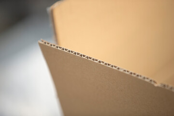 Opened cardboard box on white background. Shallow depth of field.