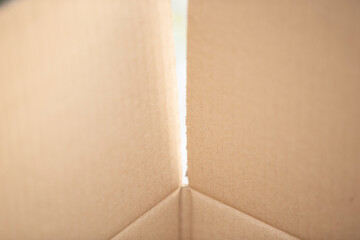 Opened cardboard box on white background. Shallow depth of field.