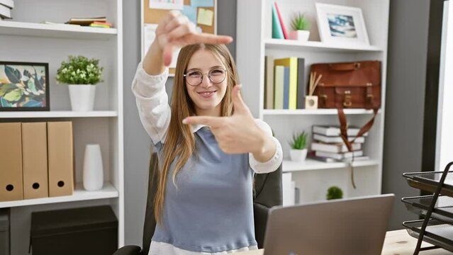 Cheerful young blonde business woman showing 'this big!' gesture in office, embodying large scale concept with hands!