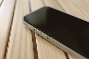 Close up of mobile phone wears white matte case left on the table.