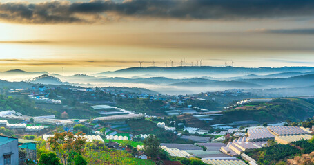 The morning landscape in the valley Da Lat, Vietnam with fog covered and sunrise background is so...