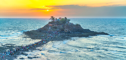 Morning sunrise landscape on Hon Ba island, Vung Tau, Vietnam with a small pagoda. People walking...