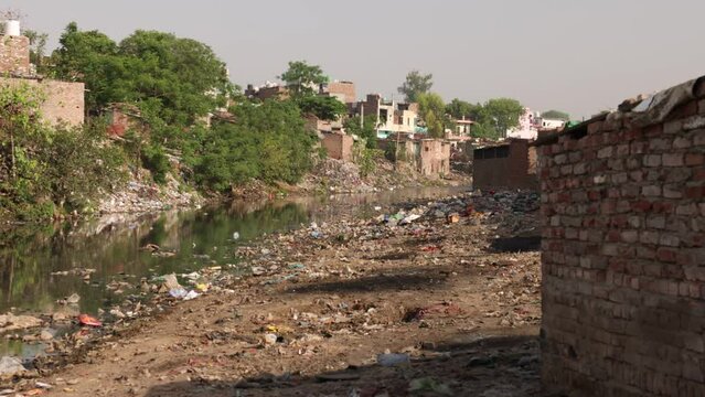 River Flowing Through Slum In India