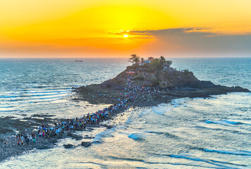 Morning sunrise landscape on Hon Ba island, Vung Tau, Vietnam with a small pagoda. People walking...