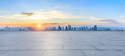 Empty square floor and city skyline with modern buildings at sunset in Chongqing