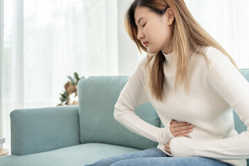 stomach ache. Asian women have abdominal pain, indigestion, gastritis, menstrual cramps,...