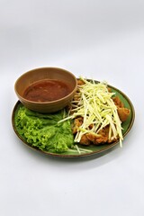 crispy chicken with mango sauce or Ayam Saus Mangga. The taste is savory spicy and a little sweet. Selective Focus
