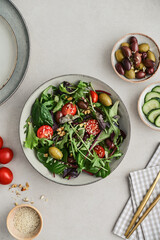 Salad with cherry tomato,  olives, cucumber and arugula
