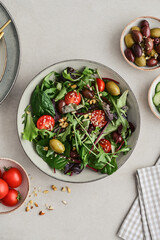 Salad with cherry tomato,  olives, cucumber and arugula