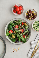 Salad with cherry tomato,  olives, cucumber and arugula