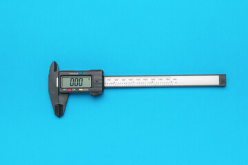 Electronic vernier caliper with zero readings on a blue background.