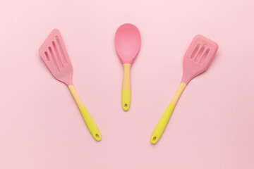 A set of bright silicone shoulder blades on a pink background.