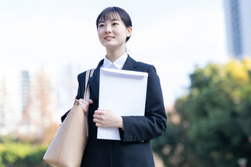 Fototapeta premium 封筒を抱えて歩く就活生