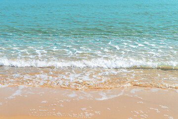 Fototapeta na wymiar Soft wave of the sea on the sandy beach. Background and texture