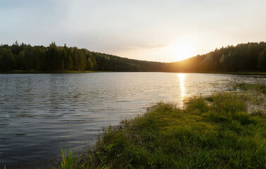 Beautiful sunset on the lake. Landscape with lake and forest