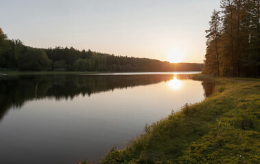Fototapeta na wymiar Sunset on the lake in the woods. Summer landscape. Russia.