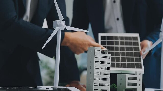 Diverse group of business people planning for alternative energy utilization for greener sustainable Earth by reducing CO2 emission and carbon credit with renewable clean energy technology. Quaint