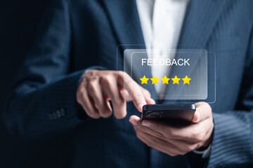 Feedback concept. Customer review satisfaction feedback survey, satisfaction feedback review. Businessman use smartphone to give rating to service experience on online application on smartphone.