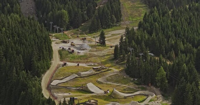 Whistler BC Canada Aerial v15 zoomed birds eye view drone flyover capturing mountain bike park's challenging slopes, uphill lift and lush forested surroundings - Shot with Mavic 3 Pro Cine - July 2023