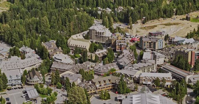Whistler BC Canada Aerial v4 zoomed birds eye view drone flyover resort village town, tilt up reveals sliding centre at Blackcomb mountain during summer season - Shot with Mavic 3 Pro Cine - July 2023