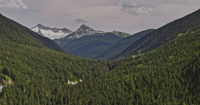 Whistler BC Canada Aerial v5 zoomed drone flyover capturing breathtaking views of forest valleys and mountain peaks, with the gondola crossing the landscape - Shot with Mavic 3 Pro Cine - July 2023