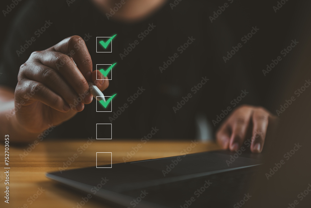 Poster Checklist concept. Businessman use pen Checking mark on checkboxes for business performance monitoring and evaluation.