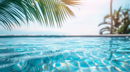 Fototapeta na wymiar Palm fronds overhanging a calm blue swimming pool in a tropical setting.